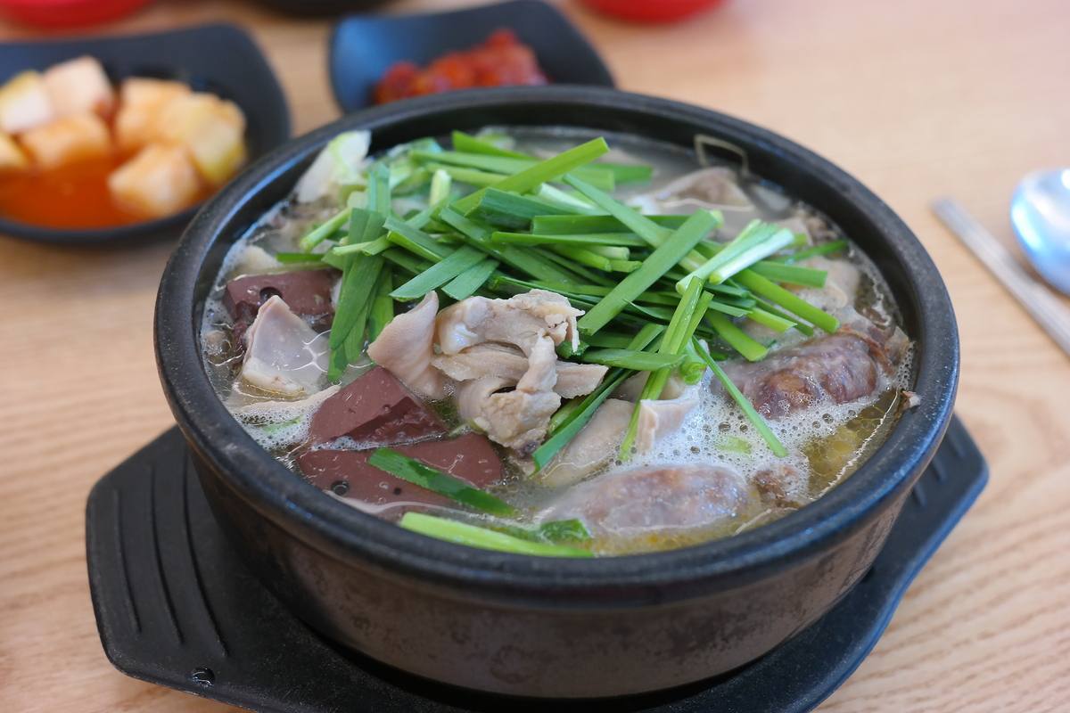A steaming bowl of Busan dwaeji gukbap (pork soup rice)