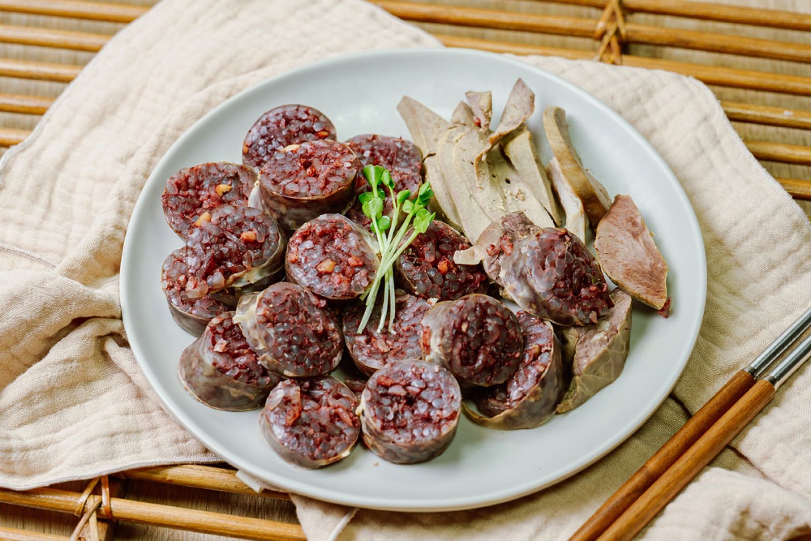 A platter of sliced Byeongcheon sundae (Korean blood sausage) with slices of liver and offal