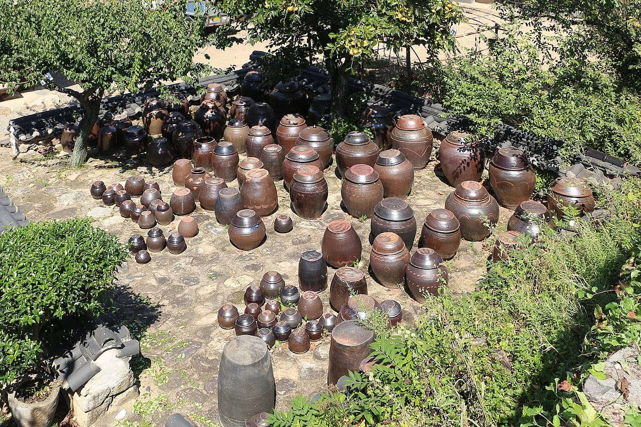 Rows of traditional Korean onggi earthenware jars on a stone terrace