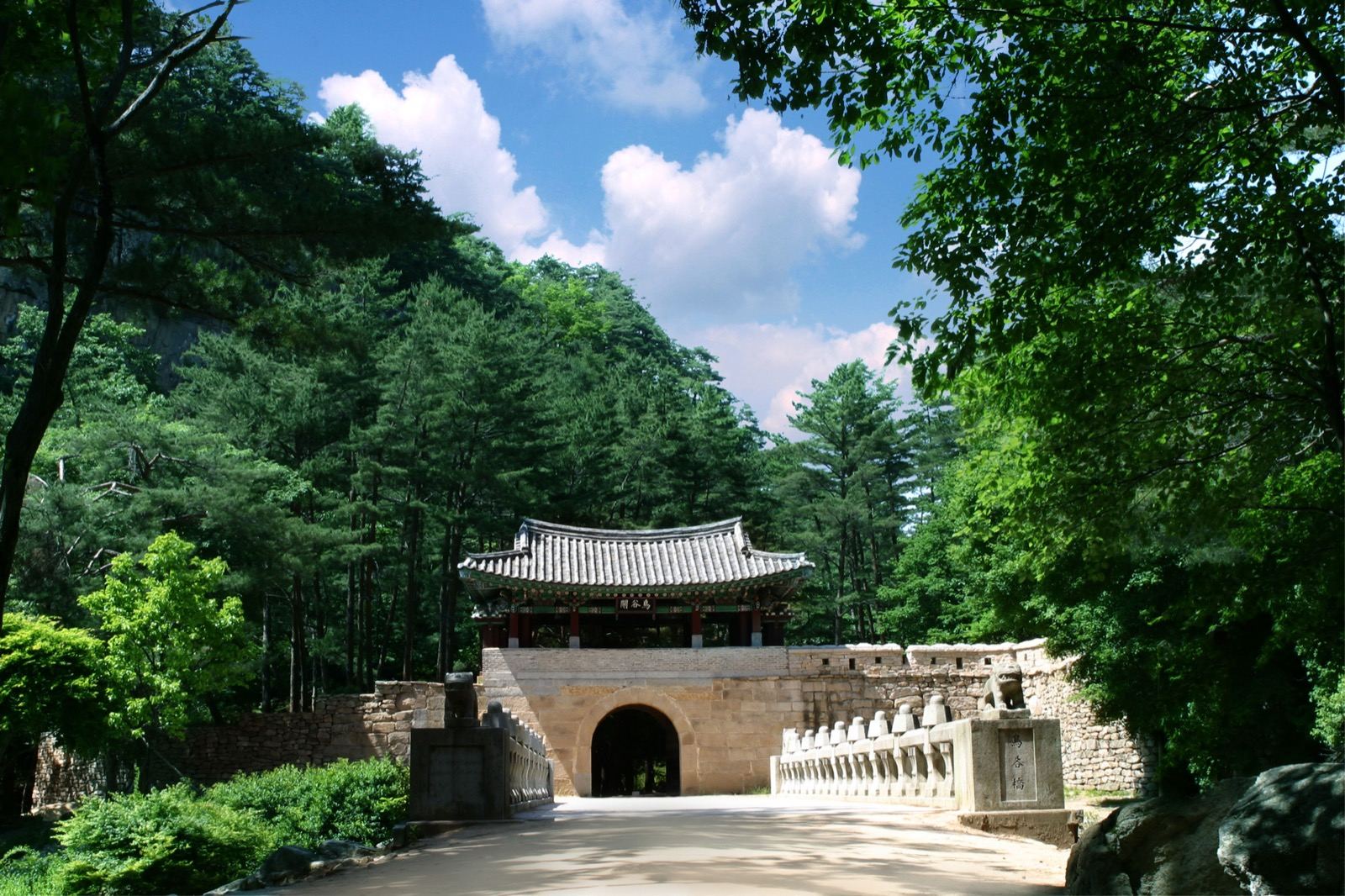 The arched stone gate and tiled gatehouse of Jogokgwan on the Mungyeong Saejae mountain pass